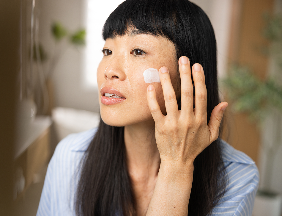 woman putting on face cream